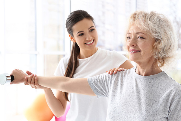 A senior and a young woman doing exercises together.